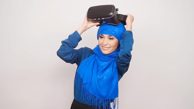 A young Muslim woman with virtual reality glasses