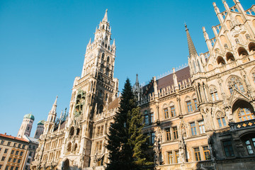 Fototapeta na wymiar Town Hall Marienplatz in the central square of Munich, the center of the pedestrian zone and one of the main attractions of the city center. It is considered the heart of Munich. An ancient building.