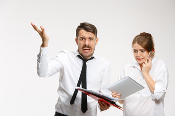 The business man and woman communicating on a gray background