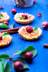 Apple caramel little tarts on blue rustic background. French tatin with paradise apple