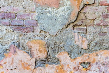 background texture old brick wall with remnants of varicoloured plasters