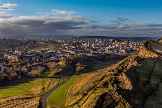 view across Edinburgh from Salisbury crags with rain clouds in the distance