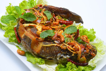 fried snakehead fish serve with herb and spicy sauce
