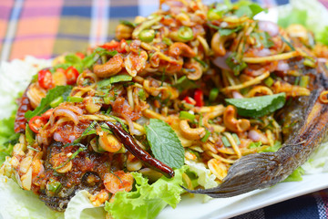 fried snakehead fish serve with herb and spicy sauce