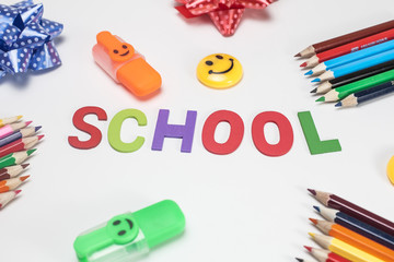 Back to school concept with highlighter,color pencil,yellow smile icon magnet  on white background