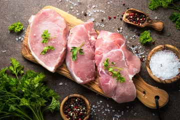 Foto op Plexiglas Fresh meat. Raw pork steak. Top view on stone table. © nadianb