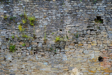 texture of old medieval castle wall with loophole made from gray stones