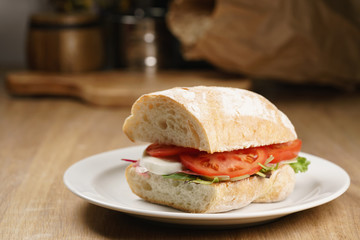 ciabatta sandwich with speck, mozzarella and vegetables