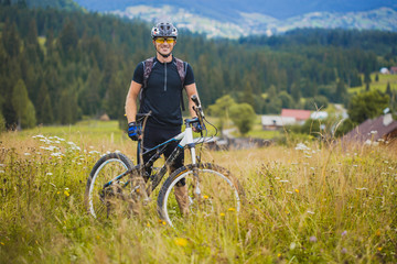young man riding a bicycle on the high plateau