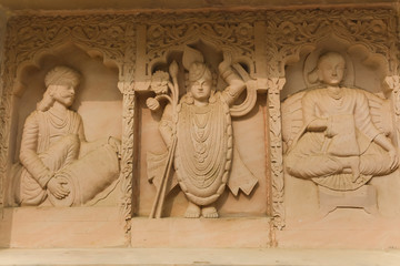 Fototapeta na wymiar Sculpture on the yellow wall of india temple Govardhana