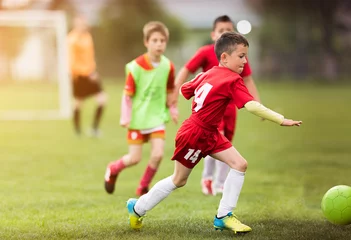 Fototapeten Kids soccer football - children players match on soccer field © Dusan Kostic