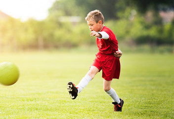 Obraz premium Kids soccer football - children players match on soccer field