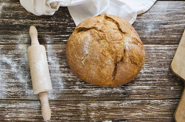 Whole wheat artisan bread on linen napkin with wood bakery rolling pin.Breads Bakery background with copy space.