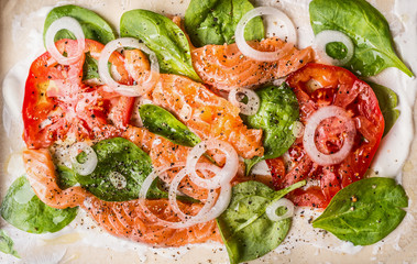Cooking preparation of  Tarte flambee with salmon and spinach, top view