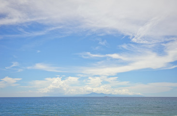 Wide view of the island of Bali and the Agung volcano on the horizon from the island of Lombok in Indonesia. 