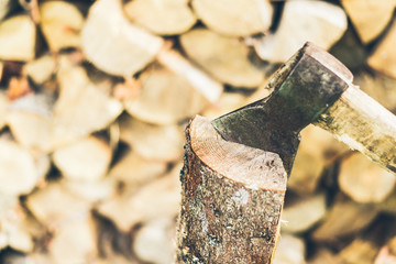 axe in log on a firewood background