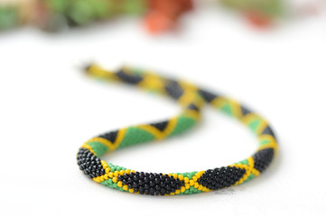 Obraz premium Bead crochet necklace in jamaican style close up