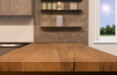 Wood table top as kitchen island on blur kitchen background - can be used for display or montage your products