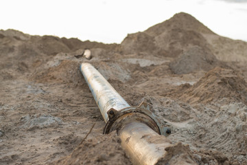 Steal big pipeline on a sand. Old pipes joint in a desert