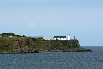 steep sea Cape with an old lighthouse © vasilevich