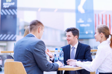 Group of happy young business people in a meeting at office