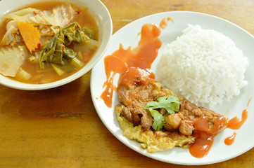 fried egg dressing chili sauce on rice eat with Thai mixed vegetable curry sweet and sour soup