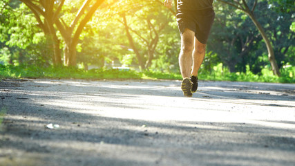 Runner feet running on road.