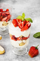 Dessert tiramisu with strawberry on a gray background