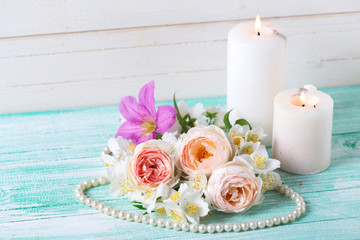 Sweet pastel  roses, jasmine flowers  and  burning candles