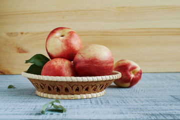 Ripe fresh nectarines in the wicker basket
