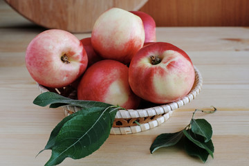 Ripe fresh nectarines in the wicker basket