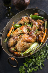 Rabbit with vegetable and mushrooms as top view in a stewpot