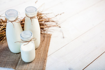 Fototapeta na wymiar bottles of milk on a wooden rustic table. copy space