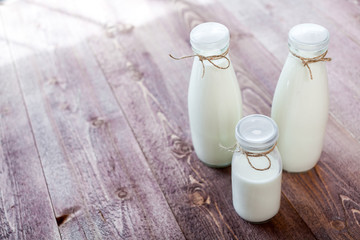 bottles of milk on a wooden rustic table. copy space