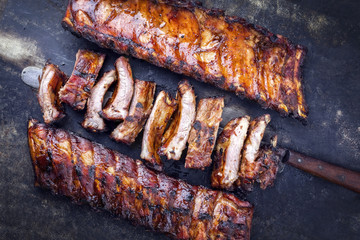 Barbecue pork spare ribs as top view on an old board