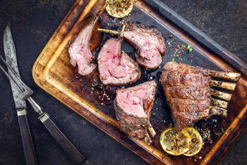 Barbecue veal loin as top view on burnt cutting board