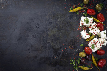 Traditional Greek Feta with Vegetable and peperoni as top view with copy space on an old rustic board