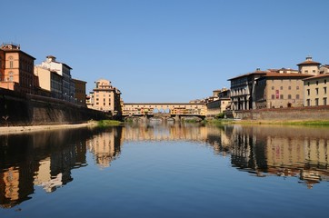 Fototapeta na wymiar Panoramic view of famous Old Bridge (Ponte Vecchio) with blue sky in Florence, Italy.