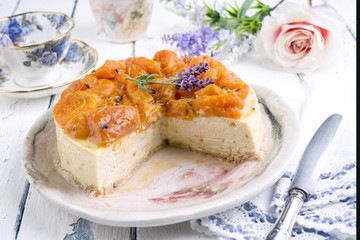 Traditional peach cheesecake as close-up on plate