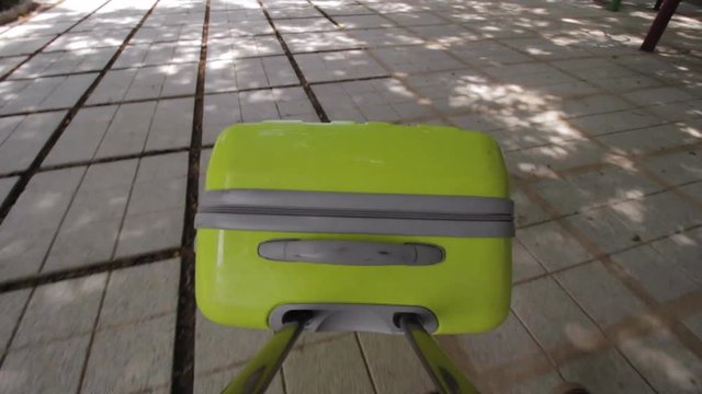 POV of Travelers walking with suitcase