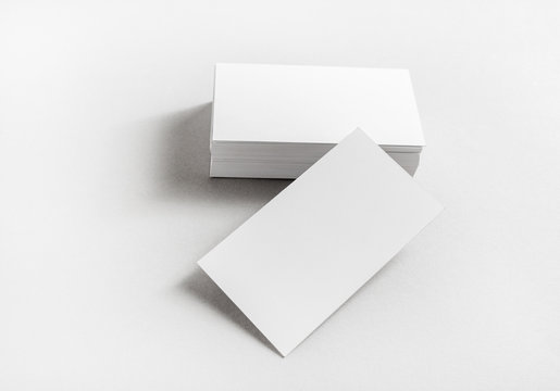 Photo of blank business cards on paper background. Template for branding identity. Mockup for ID. Studio shot.