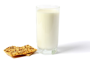 Glass of fresh milk with biscuit isolated on white background