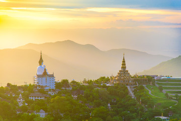 Sacred sunrise and beautiful golden sky at Pha Sorn Kaew Temple, Petchabun, Thailand. Statue of Buddha on mountain.