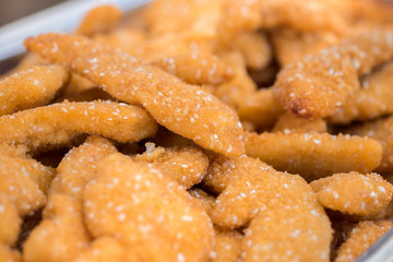 Lot of golden chicken schnitzels with sesame