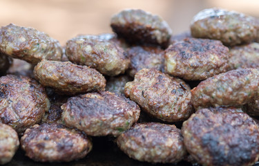 Lot of hot grilled meatballs or small hamburgers