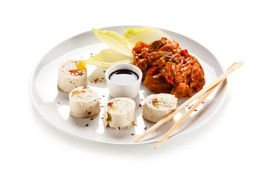 Roast, stuffed chicken roulade with rice and goulash on white background