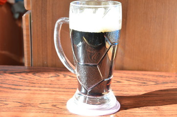 Black beer with foam and snack