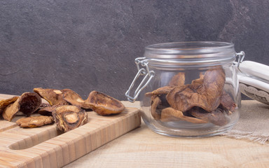 Dried forest mushrooms on a wooden table.