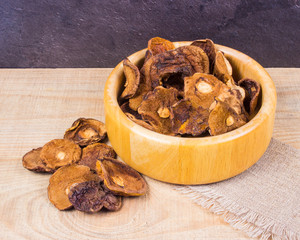 Dried forest mushrooms on a wooden table.