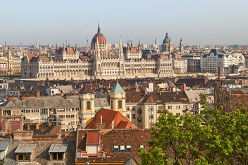 Fototapeta na wymiar View of Hungarian Parliament building over the city roofs